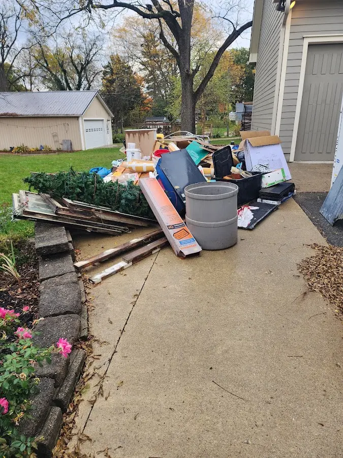 Dumpster being loaded with debris for 3 Yard Dumpster Rental in Clover Creek
